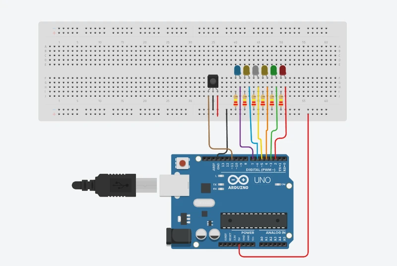 Tinkercad diagram: an IR receiver wired to pin 11, 5V and GND, and six LEDs on pins 2 to 7