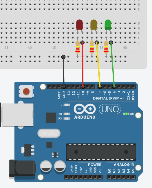Tinkercad diagram: red, yellow and green LEDs wired to pins 10, 7 and 4