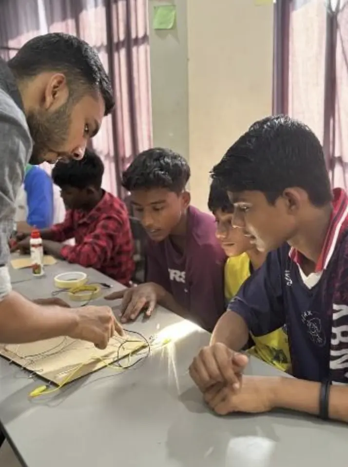 Students building quiz boards at Skill Hub with guidance