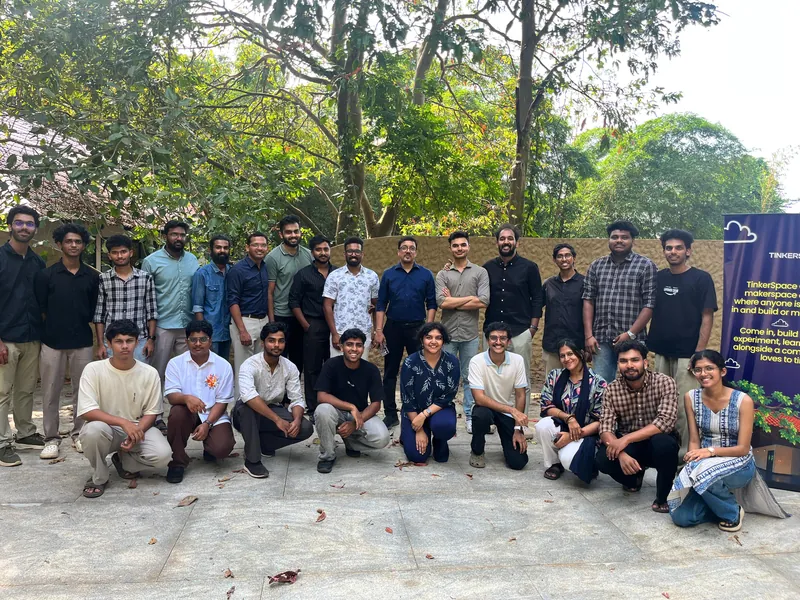 Group photo of about twenty-five participants outside TinkerSpace Calicut, under the trees