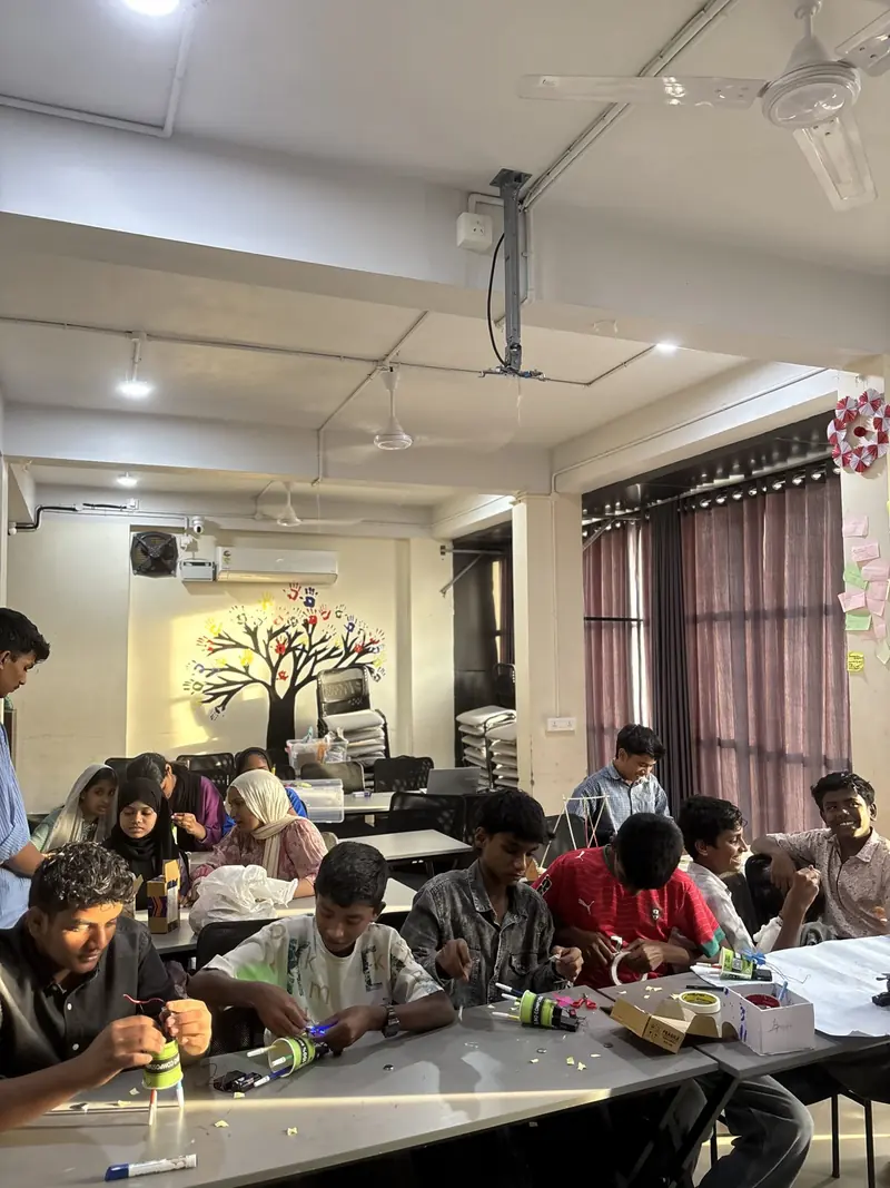 Students assembling Scribble Bots at their tables