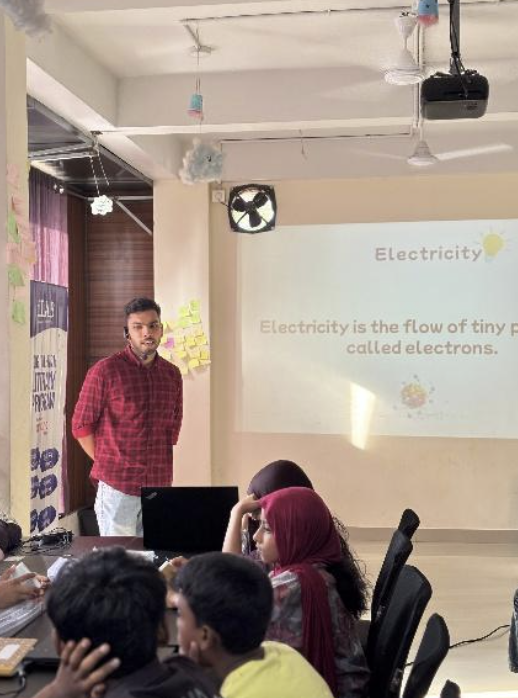Basheer introducing electricity concepts to 15 students at iLab