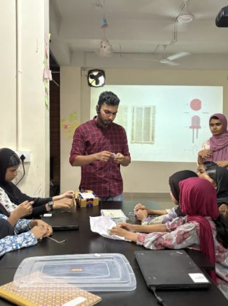 Students building circuits at Skill Hub with Basheer guiding