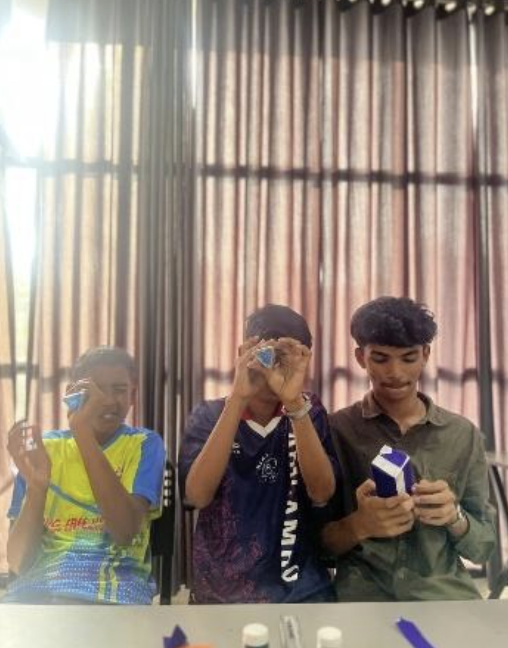 Students holding their completed kaleidoscopes