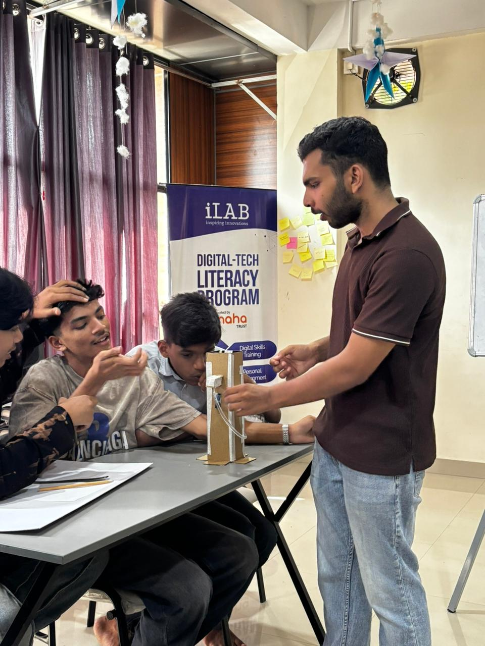 Students applying design thinking to their dispenser builds