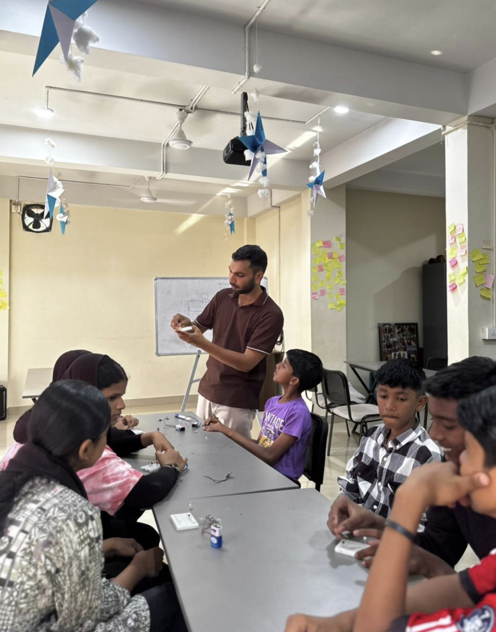 Basheer demonstrating LDR automatic street light circuit to students