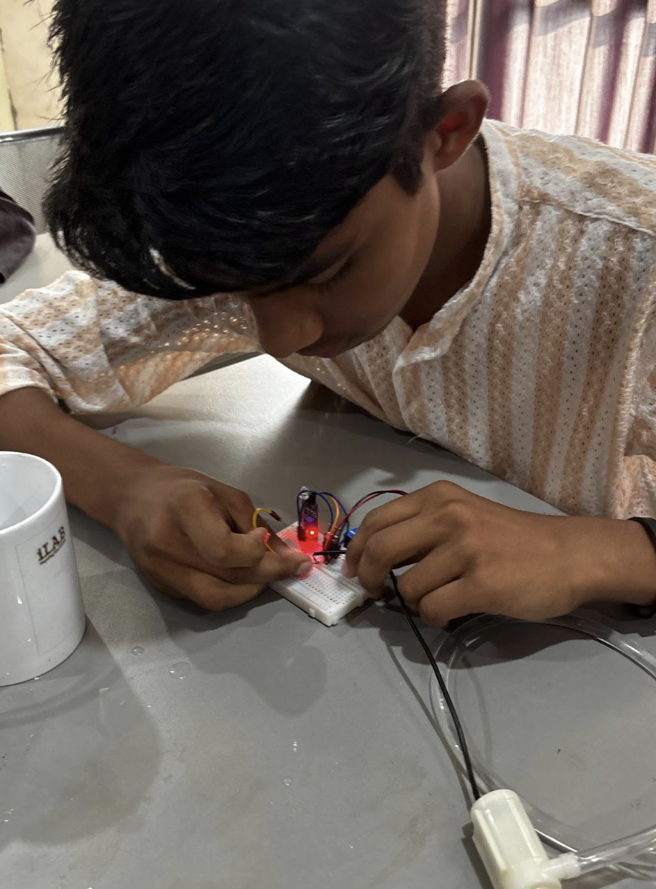 Student assembling the automatic water dispenser circuit at Skill Hub